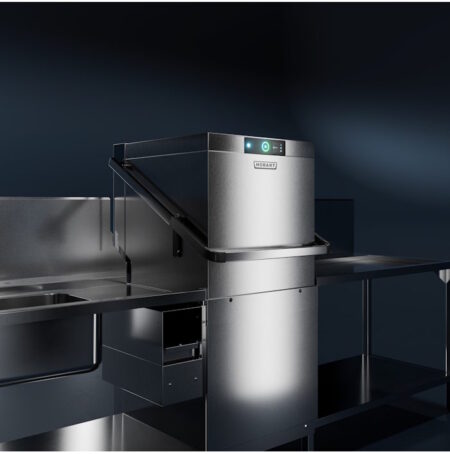 Neue HOBART Haubenspülmaschine für mehr Effizienz Hobart commercial dishwasher on a stainless steel workstation with illuminated control panel.